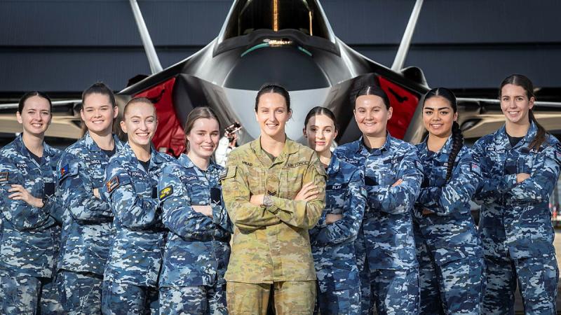 Royal Australian Air Force Corporal Samantha Mead (center) with the aviators she mentored on the Top Chicks nine-week wellbeing program for 18-25-year-olds held at 2 Operational Conversion Unit, RAAF Base Williamtown.